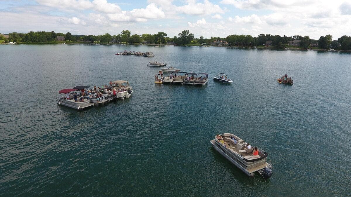 Pontoon boats gathered for a summer community event on Pickerel Lake